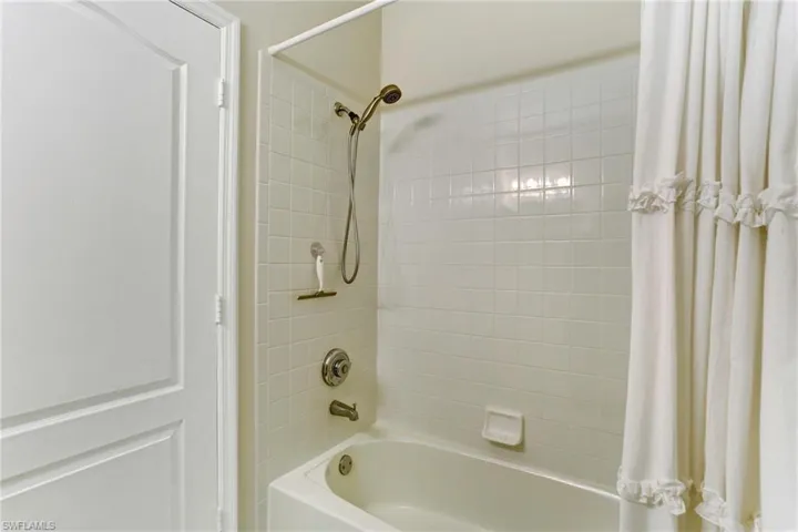 Bathroom featuring shower / bathtub combination with curtain