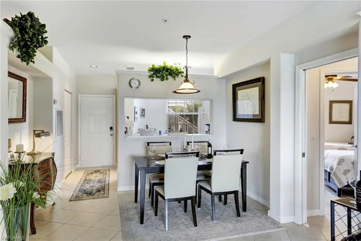 Dining room with ceiling fan and light tile patterned floors