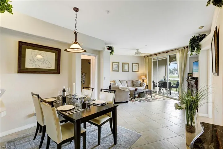 Tiled dining space featuring ceiling fan