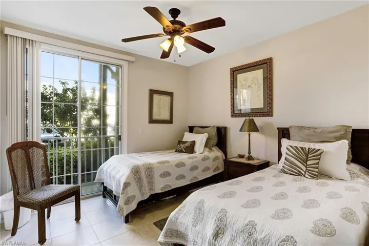 Bedroom featuring access to outside, light tile patterned floors, and ceiling fan