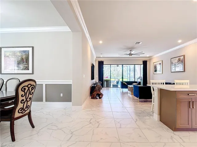 Dining room with crown molding and ceiling fan
