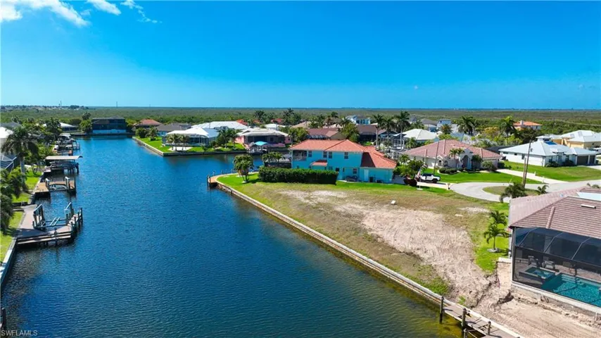 Aerial perspective of suburban area featuring a nearby body of water