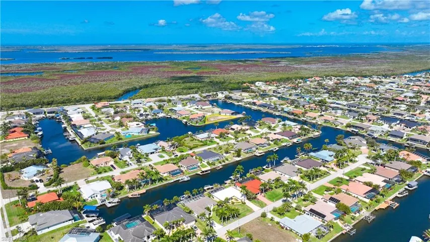 Aerial perspective of suburban area with a nearby body of water