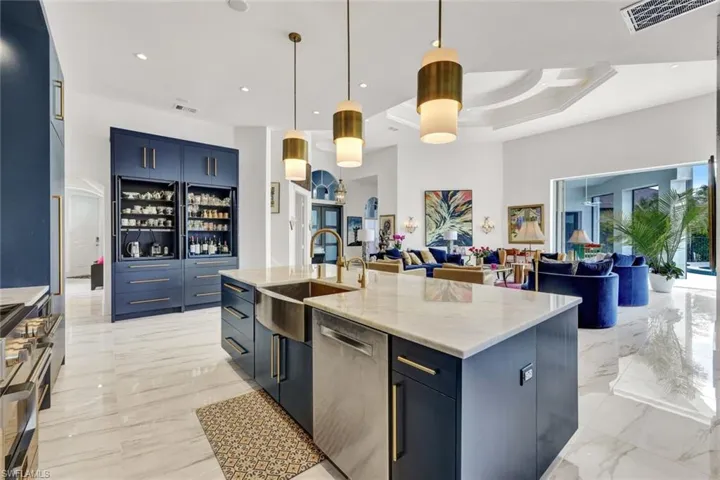 A statement kitchen that was well thought out with design. Modern pendant designer light fixtures with gold accents, Golden cabinetry pulls, and fresh and neutral access surrounding!