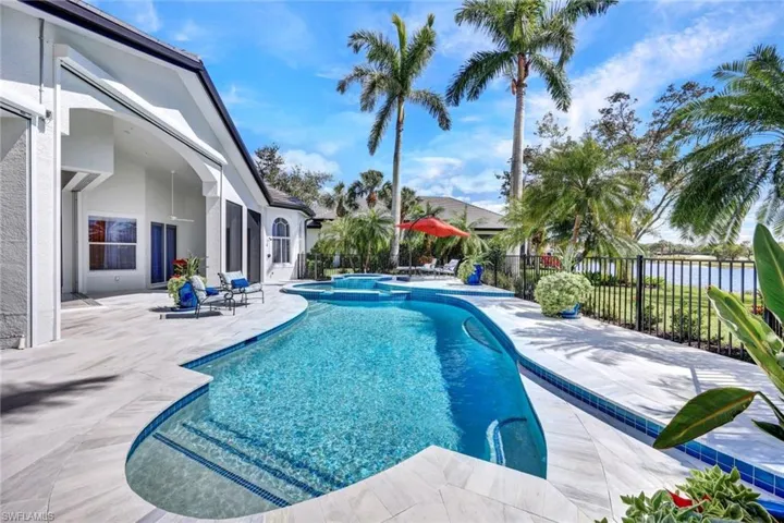 Backyard oasis with amazing lanai space, electric screens, gorgeous spacious pool, spa double shelf overflow, and Southern facing views!