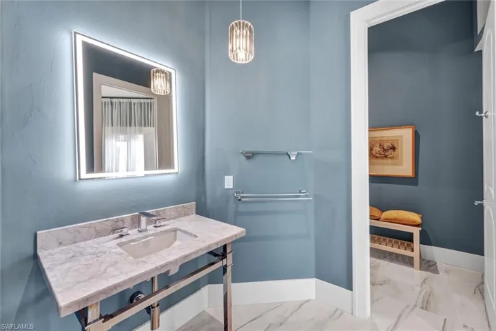 Guest bathroom with backlit mirror and lovely open vanity!
