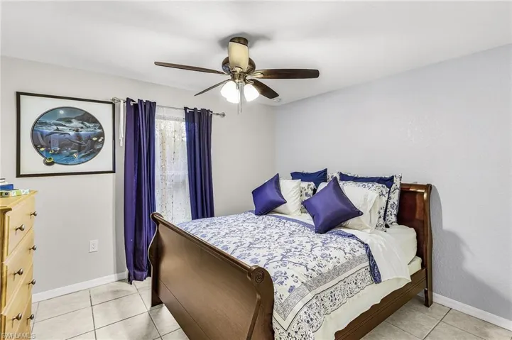 Bedroom 3 with a ceiling fan and light tile patterned floors