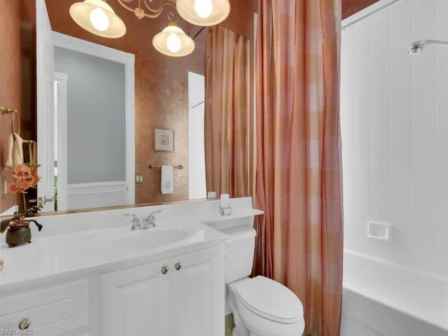 Full bathroom featuring toilet, vanity, and shower / tub combo with curtain
