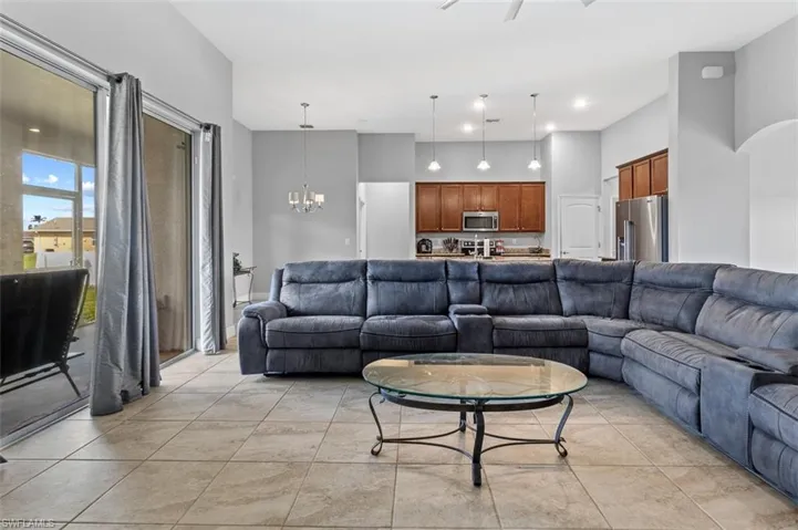 Living room with a notable chandelier and light tile floors