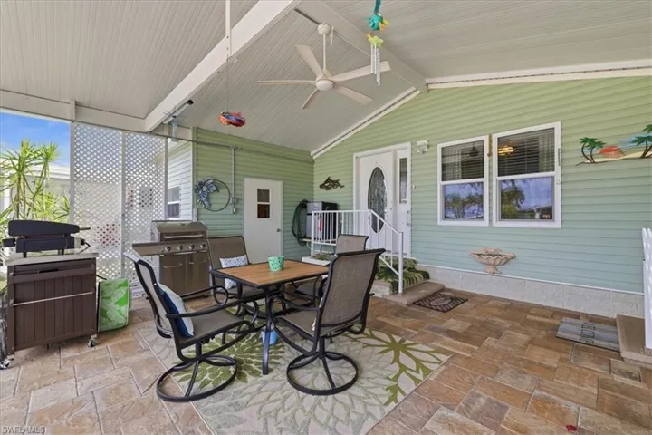 View of patio with outdoor dining area and grilling area