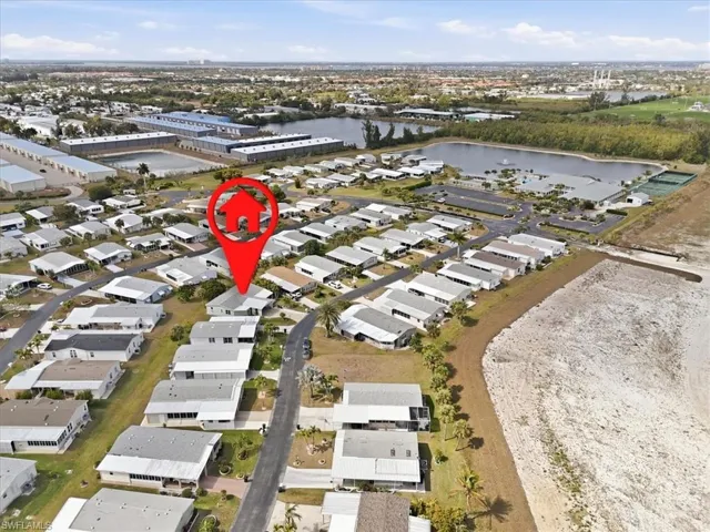 Aerial view of property and surrounding area with nearby suburban area and a large body of water