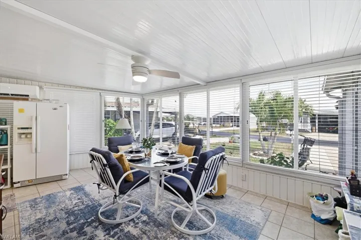 Sunroom featuring ceiling fan and outdoor dining space