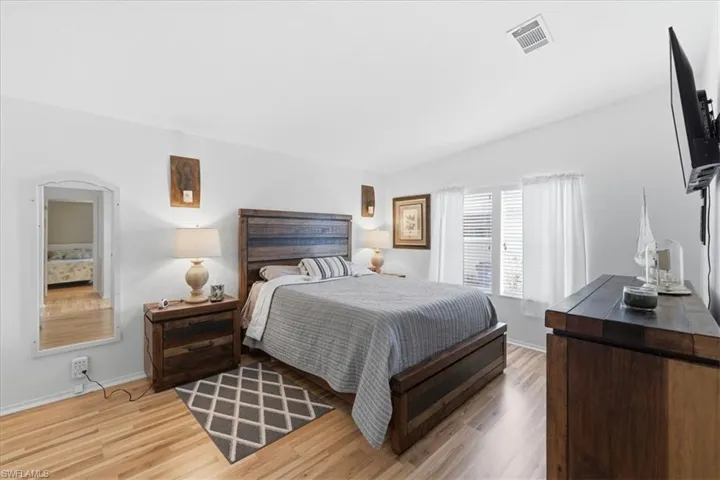 Bedroom with baseboards and light wood-type flooring