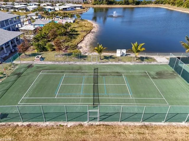 View of tennis court featuring a water view