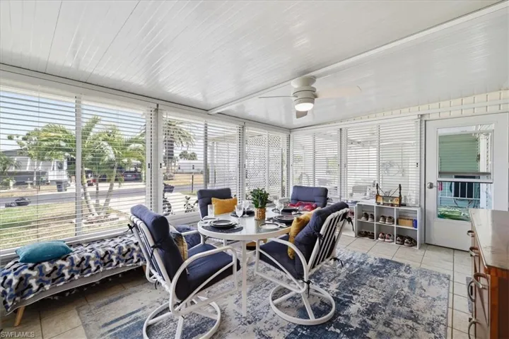 Sunroom featuring ceiling fan and outdoor dining area