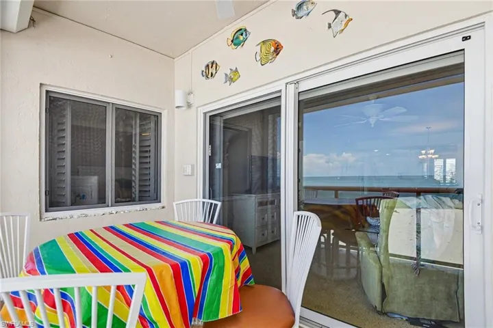 VIEW SHOWING PRIMARY SUITE SOUTHERN WINDOW.  SLIDING DOORS TO LIVING AREA.  IMPACT RESISTANT WINDOWS AND DOORS.  LANAI ALSO HAS ELECTRIC SHUTTERS.