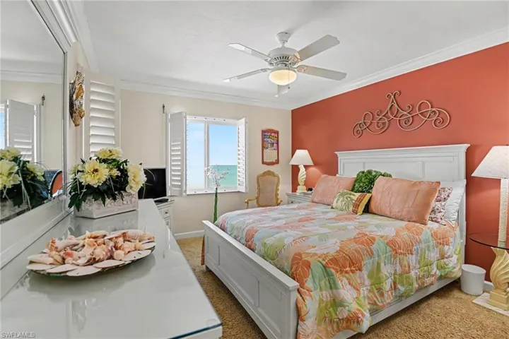 PRIMARY SUITE.  SOUTH AND WEST IMPACT WINDOWS WITH PLANTATION SHUTTERS.  CROWN MOLDING.
