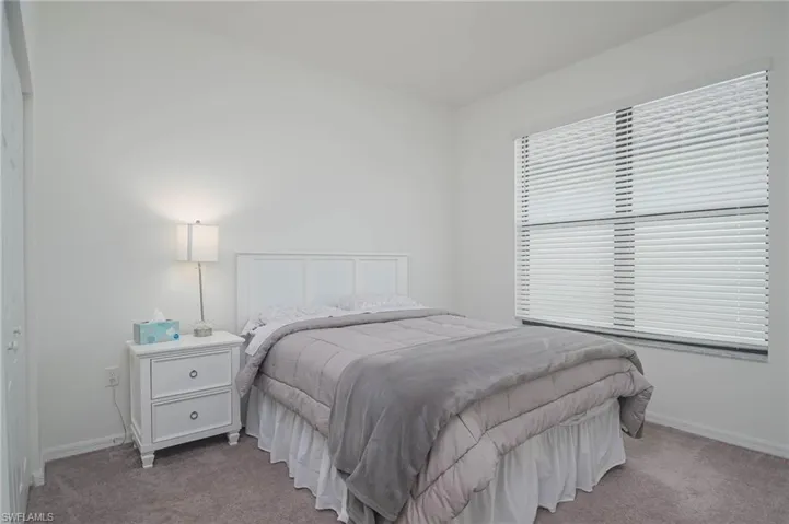Bedroom featuring carpet flooring and baseboards