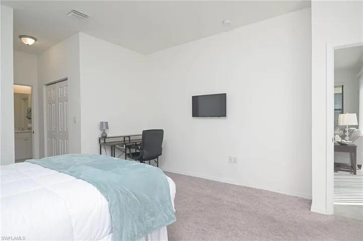 Bedroom with carpet floors, baseboards, and a closet
