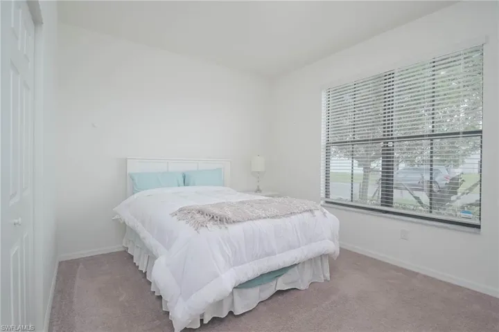 Bedroom featuring carpet and baseboards