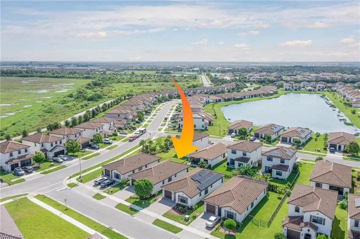 Aerial perspective of suburban area with a nearby body of water