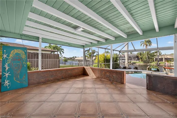 Screened patio featuring a painted wood plank ceiling and tiled flooring