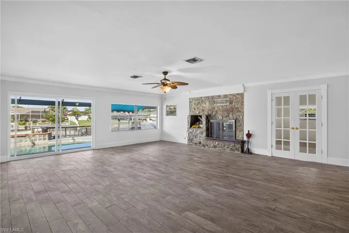Wood-finish flooring throughout, with a stone-clad fireplace and hearth