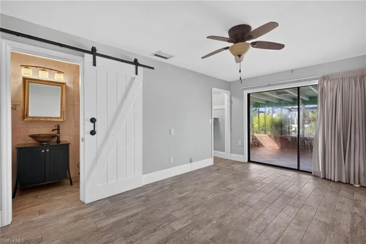 Wood-finish flooring throughout, with a ceiling fan overhead