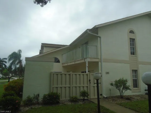 View of side of home with a balcony