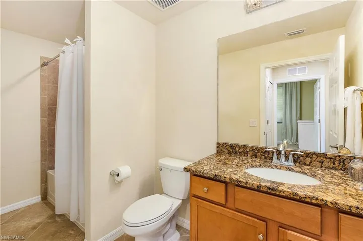 Second bathrm with shower over tub and laundry area.