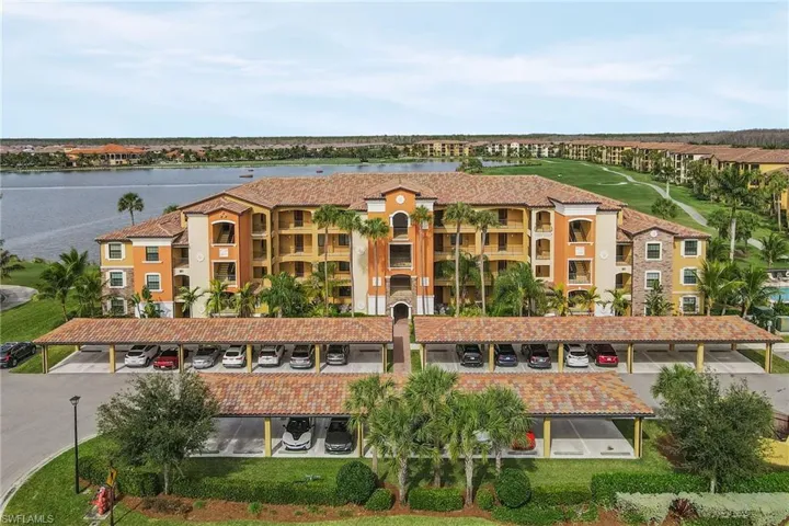 Front of building with one covered parking space and storage area.