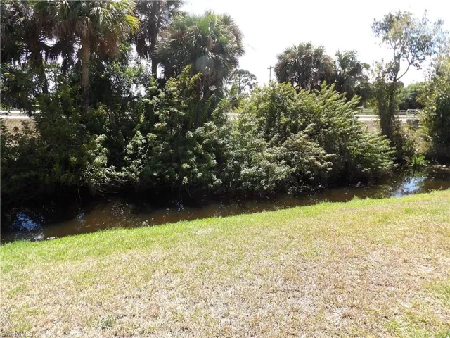 View of green lawn with a water view
