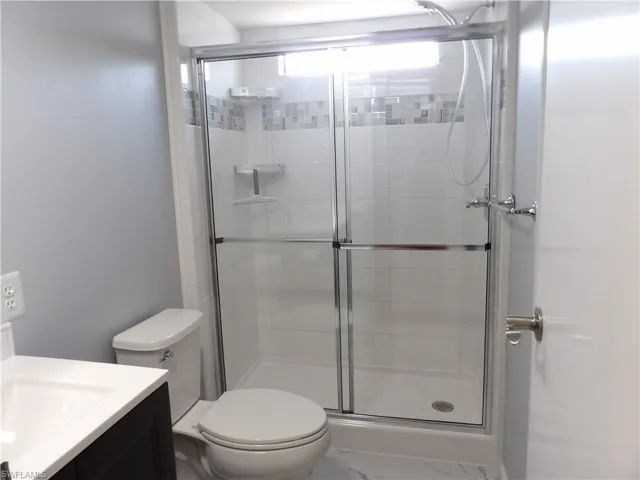 Full bath featuring vanity and a shower stall