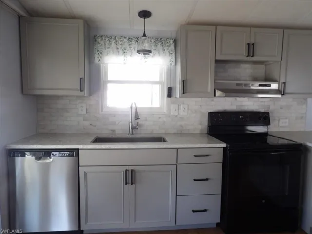 New Kitchen featuring black / electric stove, dishwasher, light stone countertops, decorative light fixtures, and tasteful backsplash