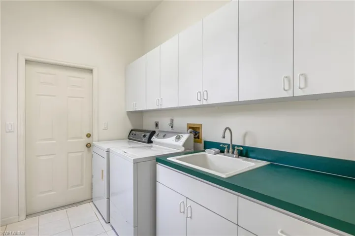 Additional storage is available in the laundry room. There is also space to create a convenient drop-off area for your items when you enter from the garage, although it is not shown.