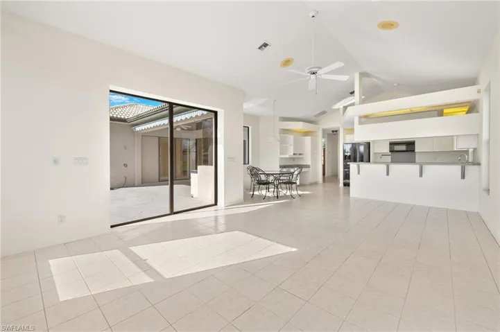 Open concept family room and kitchen area complete with a breakfast bar, eat in kitchen and small desk/work station area.