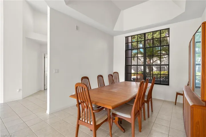 The spacious formal dining room, featuring a raised tray ceiling and abundant lighting, creates the perfect setting for entertaining.