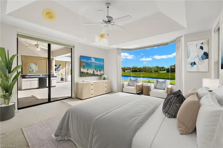 Virtually Staged Owner's Ensuite with pocketing sliding glass doors and access to the pool and lanai.