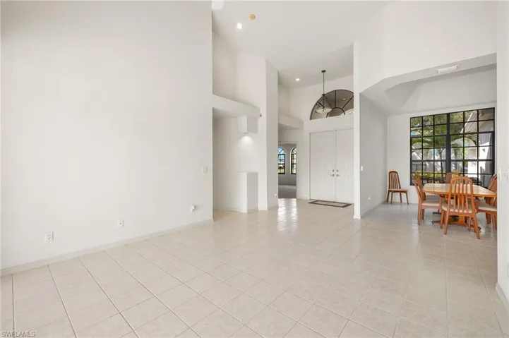 Double doors and an arched transom window warmly welcome you into the home.