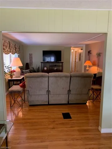 Living area featuring light wood-type flooring and baseboards