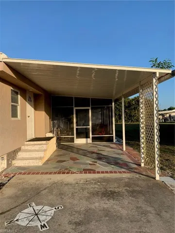 Property entrance with stucco siding
