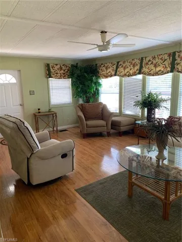 Living area featuring visible vents, ceiling fan, and light wood-type flooring