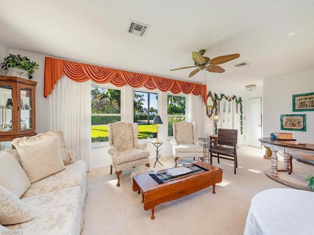 Original formal living room  with landscaped view accessible from front foyer entrance or from side two car garage.  White carpet throughout. Beautifully maintained home.
