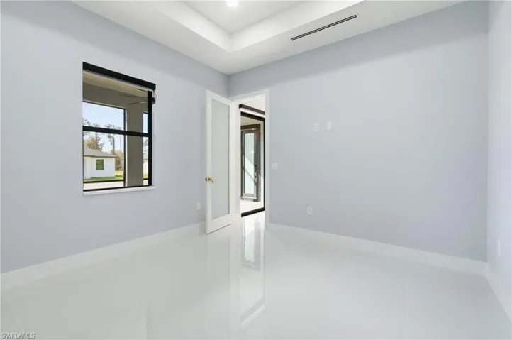 Spare room featuring tile patterned flooring and baseboards