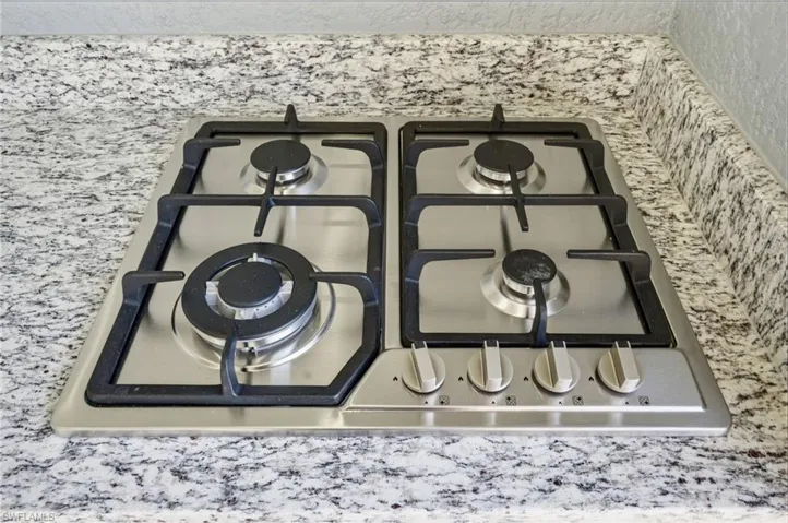 Kitchen view of stainless steel gas cooktop