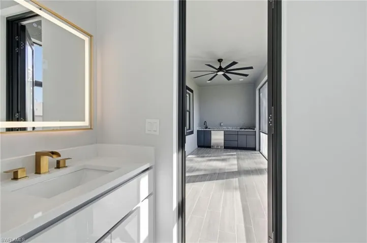 Bathroom featuring vanity, ceiling fan, and healthy amount of natural light