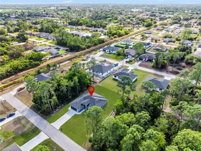 Aerial view of property's location featuring nearby suburban area