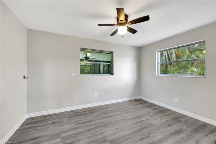 Empty room featuring ceiling fan and hardwood / wood-style flooring