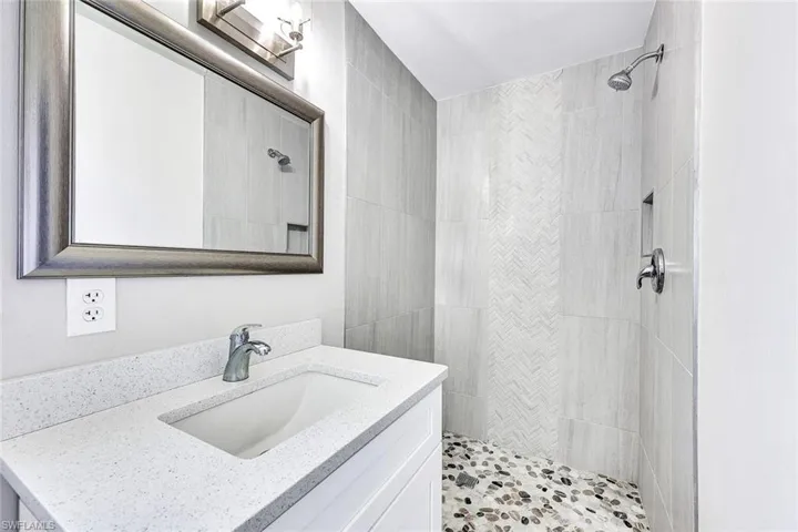 Bathroom with vanity and a tile shower