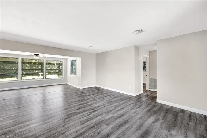 Empty room with dark hardwood / wood-style floors